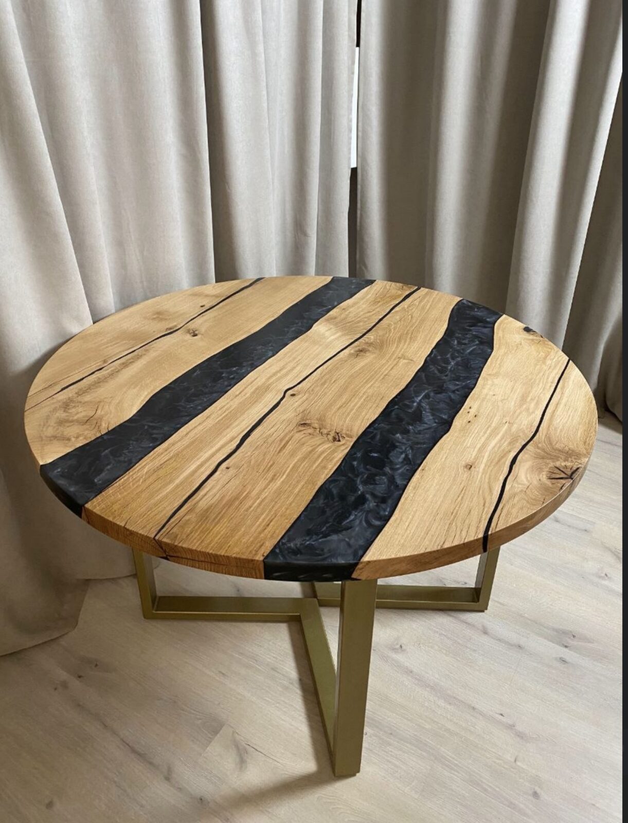 Round oak table with black epoxy river and matching clock